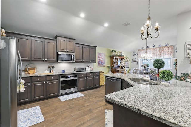 1440 Glade Meadows Dr, Burleson, TX 76058 - kitchen with appliances with stainless steel finishes, a chandelier, a sink, dark brown cabinetry, and vaulted ceiling