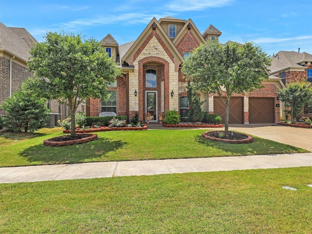 2165 Hidalgo Ln, Frisco, TX 75034 - view of front of house with brick siding, a front lawn, concrete driveway, and central AC