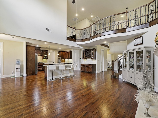 2165 Hidalgo Ln, Frisco, TX 75034 - living room featuring a towering ceiling, dark wood-style flooring, stairway, baseboards, and recessed lighting