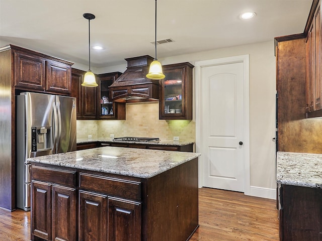 2165 Hidalgo Ln, Frisco, TX 75034 - kitchen featuring stainless steel appliances, premium range hood, wood finished floors, tasteful backsplash, and recessed lighting