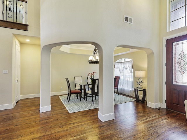 2165 Hidalgo Ln, Frisco, TX 75034 - entryway with a high ceiling, arched walkways, wood finished floors, baseboards, and a chandelier