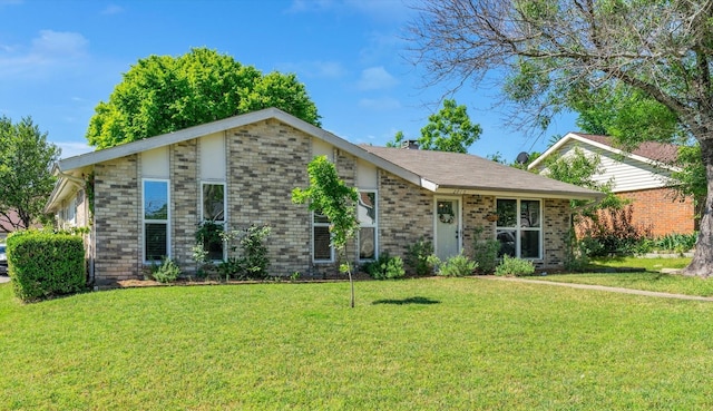 view of front of home featuring a front yard and brick siding
