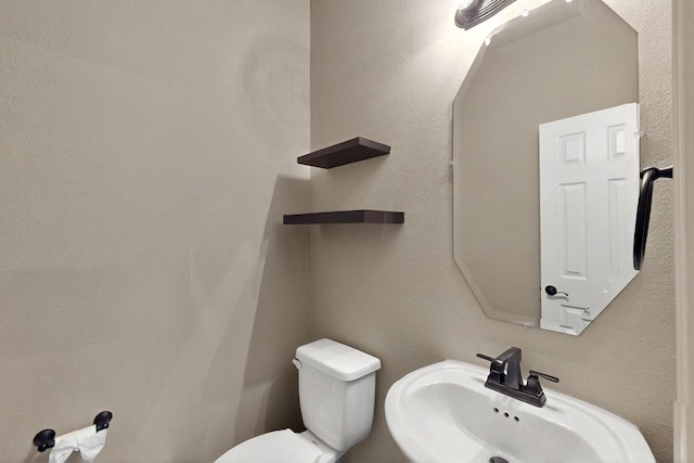 half bath featuring a sink and toilet