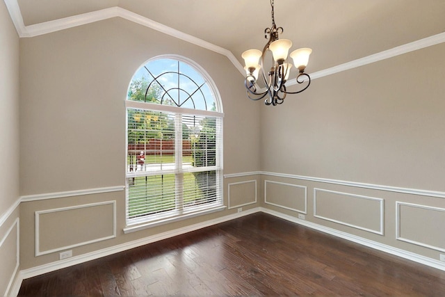 spare room featuring a chandelier, wainscoting, lofted ceiling, dark wood-type flooring, and a decorative wall