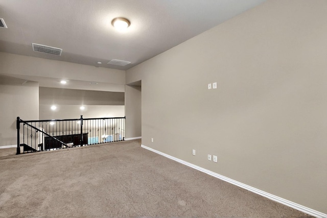 spare room with baseboards and carpet flooring