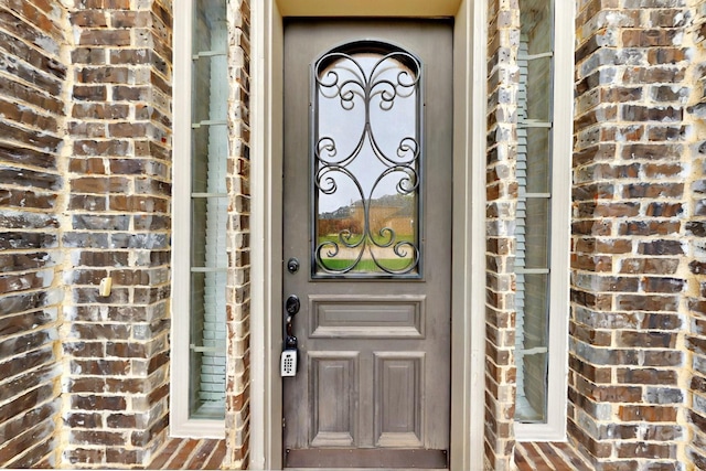 property entrance with brick siding