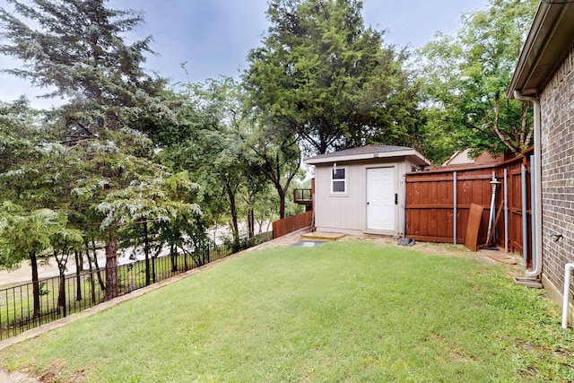 view of yard featuring a storage shed and an outbuilding