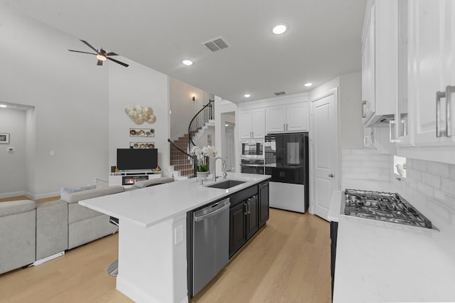 10969 Coastal Violet Rd, Frisco, TX 75035 - kitchen with appliances with stainless steel finishes, a sink, open floor plan, light wood-type flooring, and recessed lighting