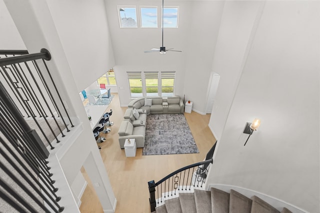 10969 Coastal Violet Rd, Frisco, TX 75035 - stairs with wood finished floors, a towering ceiling, baseboards, and a ceiling fan