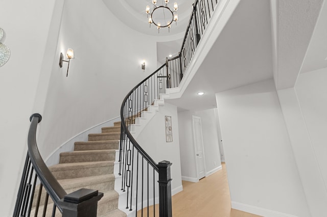 10969 Coastal Violet Rd, Frisco, TX 75035 - stairway with a high ceiling, recessed lighting, baseboards, a chandelier, and wood finished floors