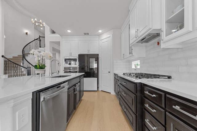 10969 Coastal Violet Rd, Frisco, TX 75035 - kitchen featuring appliances with stainless steel finishes, a sink, white cabinets, light countertops, and recessed lighting