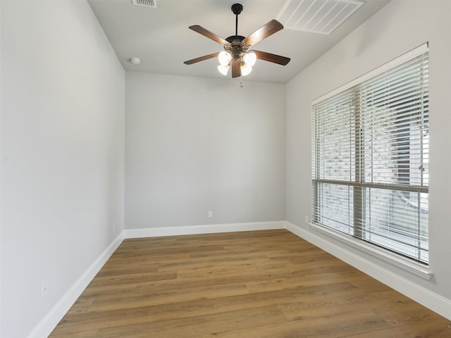 1504 Bull St, Aubrey, TX 76227 - unfurnished room with plenty of natural light, ceiling fan, baseboards, and wood finished floors