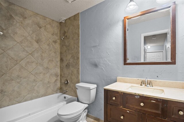 bathroom with a textured ceiling, toilet, vanity, shower / tub combination, and a textured wall