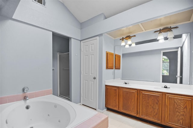 bathroom featuring a whirlpool tub, lofted ceiling, a stall shower, double vanity, and tile patterned floors