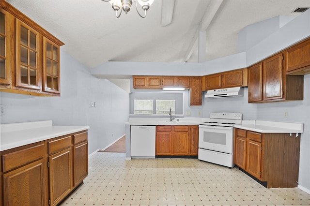 kitchen featuring white appliances, a sink, under cabinet range hood, brown cabinetry, and beamed ceiling