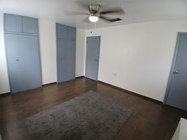 3304 Gorton Rd, Shreveport, LA 71119 - unfurnished bedroom featuring multiple closets, dark wood-type flooring, and ceiling fan