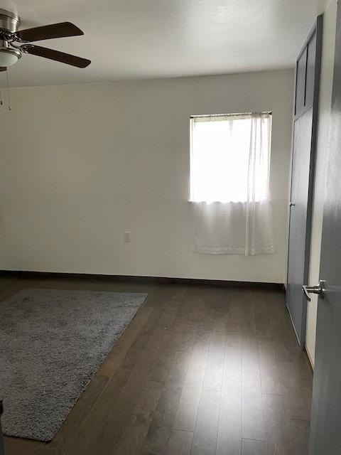 spare room featuring a ceiling fan and wood finished floors