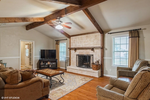 5920 Retta Mansfield Rd, Burleson, TX 76028 - living area featuring plenty of natural light, ceiling fan, wood finished floors, and a stone fireplace