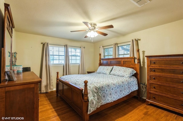 5920 Retta Mansfield Rd, Burleson, TX 76028 - bedroom with dark wood finished floors, a ceiling fan, and a textured ceiling