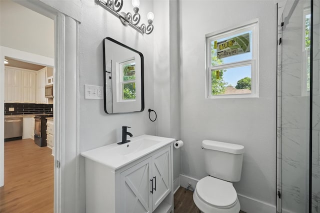 full bath featuring wood finished floors, tasteful backsplash, vanity, toilet, and a shower with door