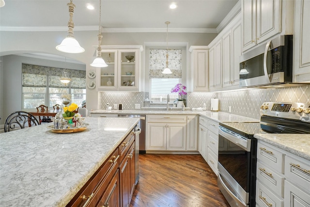 517 Hearth Ter, Argyle, TX 76226 - kitchen featuring appliances with stainless steel finishes, a sink, arched walkways, glass insert cabinets, and tasteful backsplash
