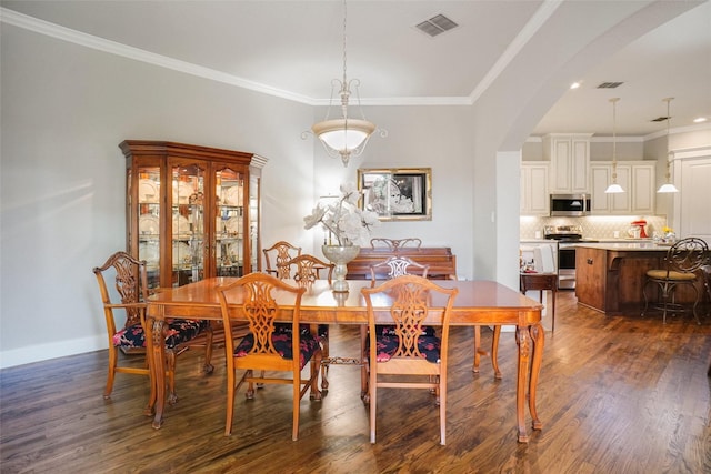 517 Hearth Ter, Argyle, TX 76226 - dining area featuring arched walkways, dark wood finished floors, ornamental molding, baseboards, and recessed lighting