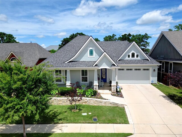 517 Hearth Ter, Argyle, TX 76226 - craftsman-style house with driveway, a front yard, a shingled roof, an attached garage, and covered porch