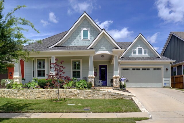 517 Hearth Ter, Argyle, TX 76226 - craftsman house with driveway, a shingled roof, a front lawn, an attached garage, and covered porch