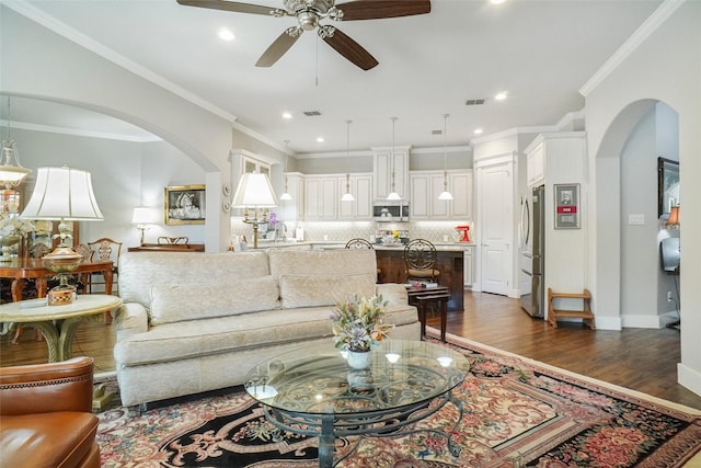 517 Hearth Ter, Argyle, TX 76226 - living room with a ceiling fan, arched walkways, dark wood-style flooring, recessed lighting, and crown molding