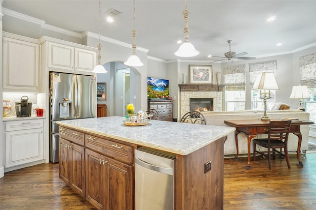 517 Hearth Ter, Argyle, TX 76226 - kitchen featuring stainless steel fridge, a ceiling fan, ornamental molding, dark wood-type flooring, and a center island