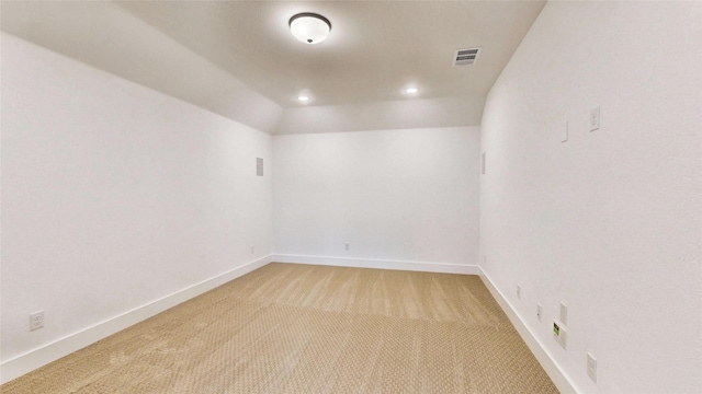 spare room featuring light carpet, baseboards, and recessed lighting