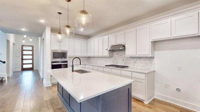 kitchen with a sink, appliances with stainless steel finishes, decorative backsplash, white cabinetry, and recessed lighting