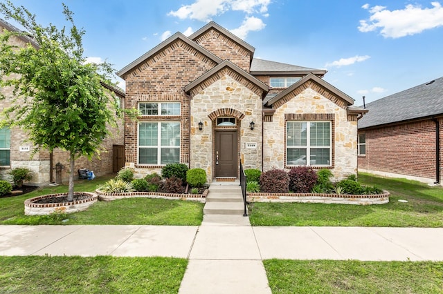 2148 Miramar Dr, Little Elm, TX 75068 - french country inspired facade with stone siding, a front yard, and brick siding
