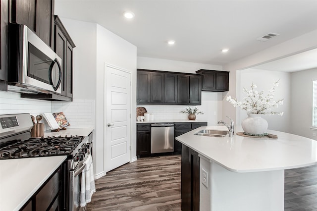 2148 Miramar Dr, Little Elm, TX 75068 - kitchen featuring appliances with stainless steel finishes, a sink, dark wood-style floors, light countertops, and recessed lighting