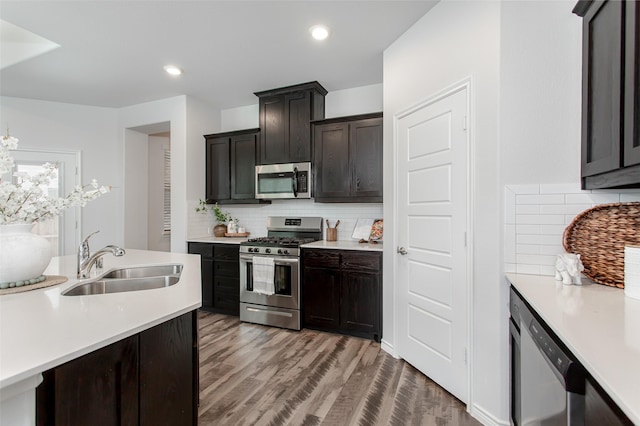 2148 Miramar Dr, Little Elm, TX 75068 - kitchen with appliances with stainless steel finishes, a sink, light countertops, tasteful backsplash, and recessed lighting