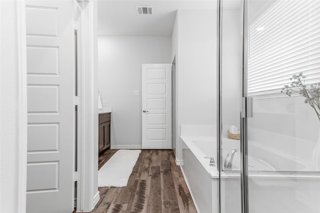 2148 Miramar Dr, Little Elm, TX 75068 - bathroom featuring wood finished floors, a bath, and vanity