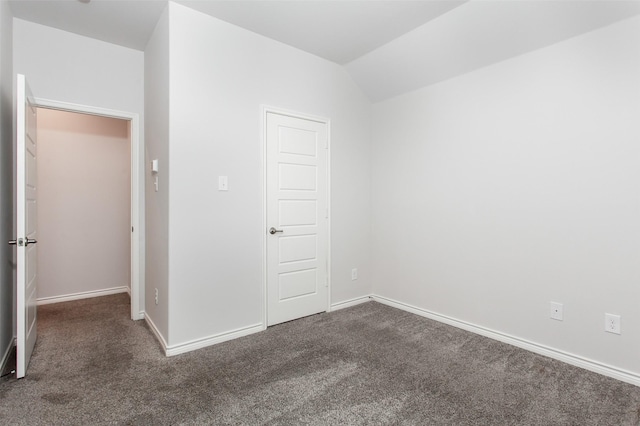 2148 Miramar Dr, Little Elm, TX 75068 - empty room with dark colored carpet, baseboards, and vaulted ceiling