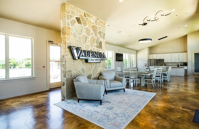 2148 Miramar Dr, Little Elm, TX 75068 - living room with finished concrete floors, lofted ceiling, and baseboards