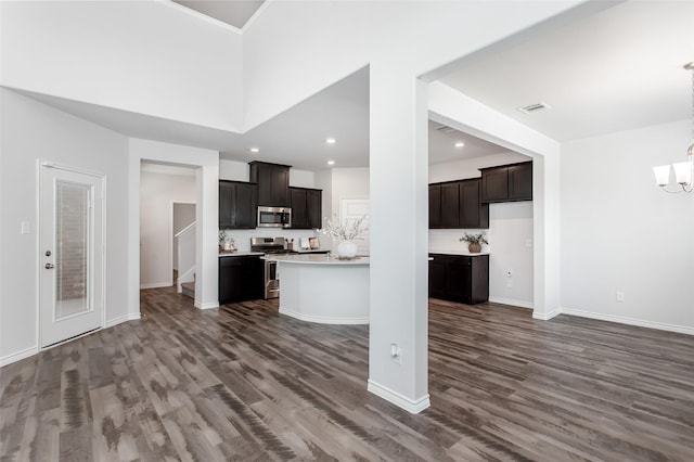 2148 Miramar Dr, Little Elm, TX 75068 - kitchen featuring stainless steel appliances, a chandelier, dark wood finished floors, light countertops, and baseboards
