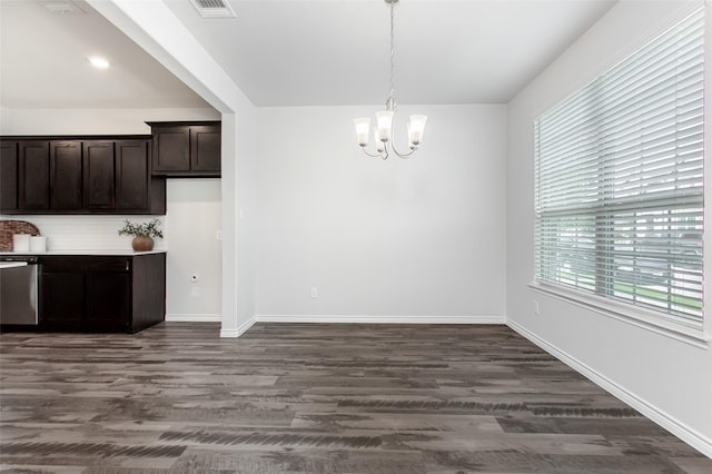 2148 Miramar Dr, Little Elm, TX 75068 - unfurnished dining area featuring a chandelier, dark wood-type flooring, and baseboards