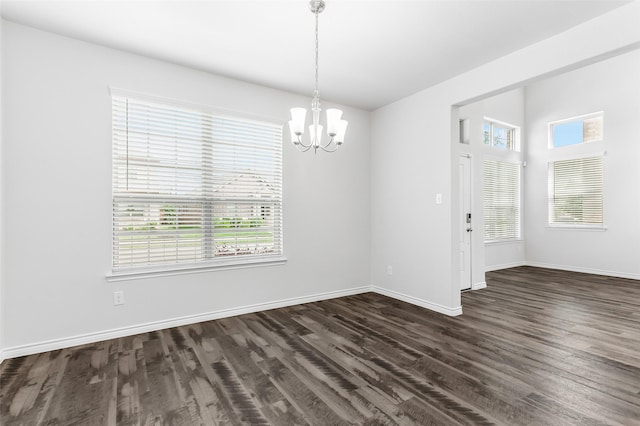 2148 Miramar Dr, Little Elm, TX 75068 - unfurnished dining area featuring a chandelier, dark wood-type flooring, and baseboards