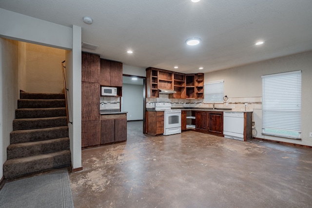 2687 Mcclendon Rd, Weatherford, TX 76088 - kitchen with white appliances, open shelves, concrete floors, recessed lighting, and backsplash