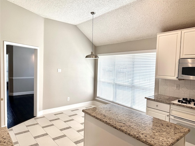 kitchen featuring white appliances, a textured ceiling, tasteful backsplash, lofted ceiling, and decorative light fixtures
