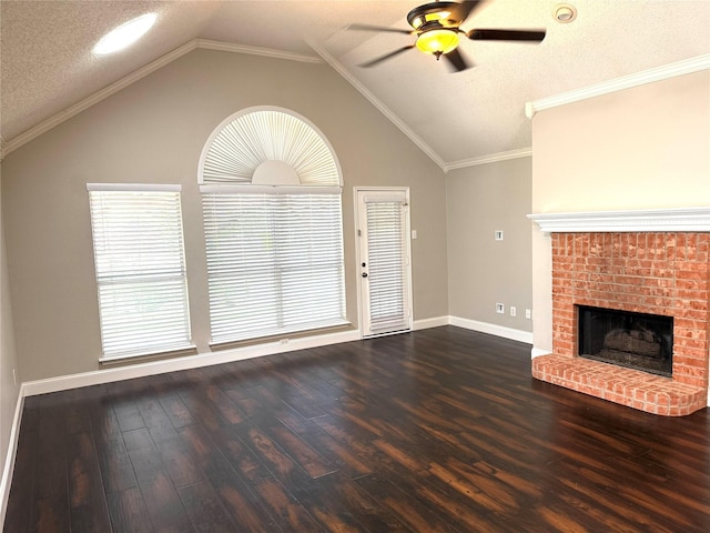 unfurnished living room with a ceiling fan, lofted ceiling, dark wood-style flooring, a brick fireplace, and a textured ceiling
