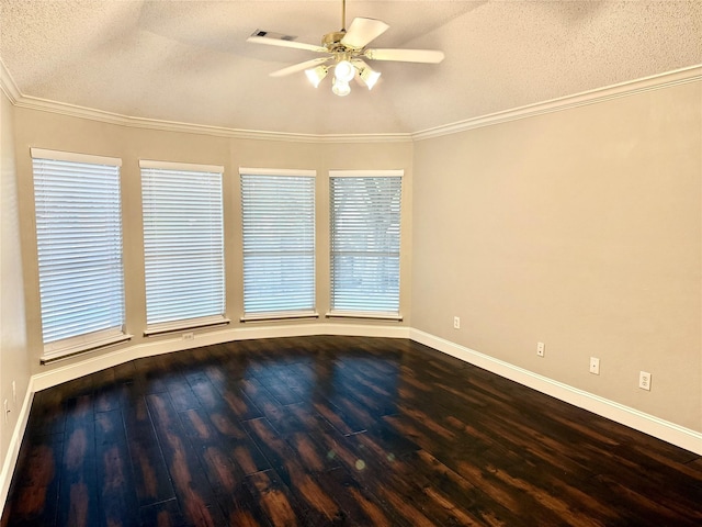 empty room featuring a textured ceiling, ceiling fan, dark wood finished floors, baseboards, and ornamental molding