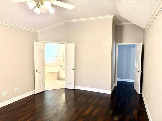 unfurnished bedroom featuring lofted ceiling, crown molding, dark wood-style flooring, a textured ceiling, and connected bathroom