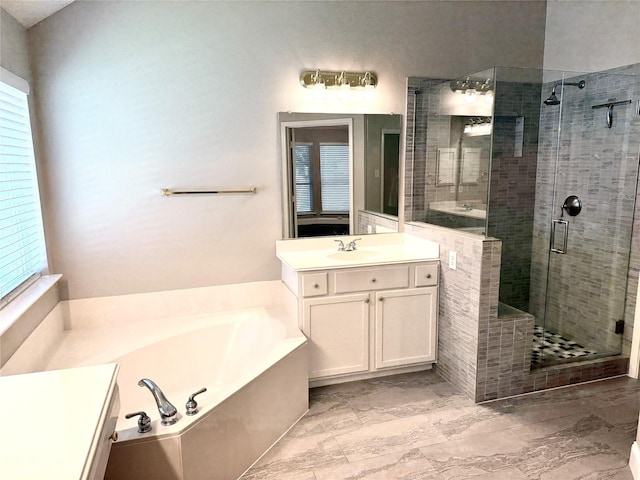 bathroom with a shower stall, a bath, vanity, and marble finish floors