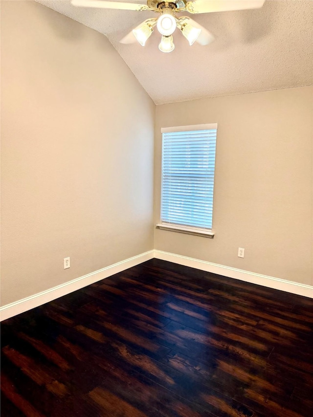 spare room with ceiling fan, wood finished floors, baseboards, lofted ceiling, and a textured ceiling