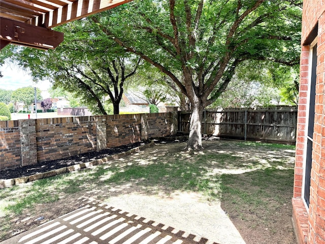 fenced backyard featuring a pergola