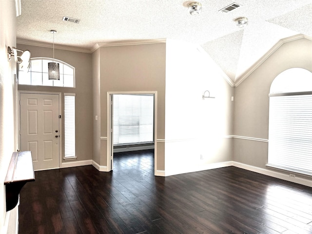 foyer featuring a textured ceiling, ornamental molding, dark wood-style floors, and baseboards